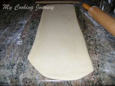 rolling the croissant dough again