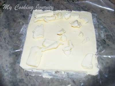 rolling the butter for layering the croissant dough
