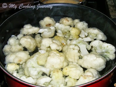 Boiling cauliflower florets in hot water to make manchurian Boiling cauliflower florets in hot water to make manchurian