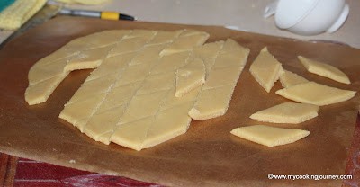 Shaping the prepared almond burfi Shaping the prepared almond burfi