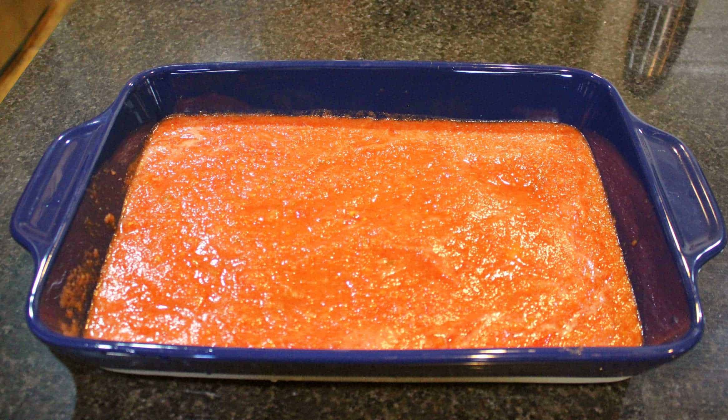 tomato sauce in a blue casserole dish