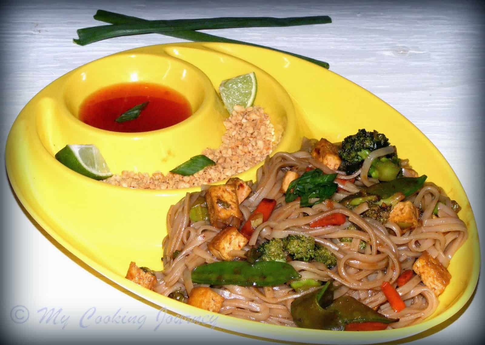 noodles with vegetables in a yellow plate
