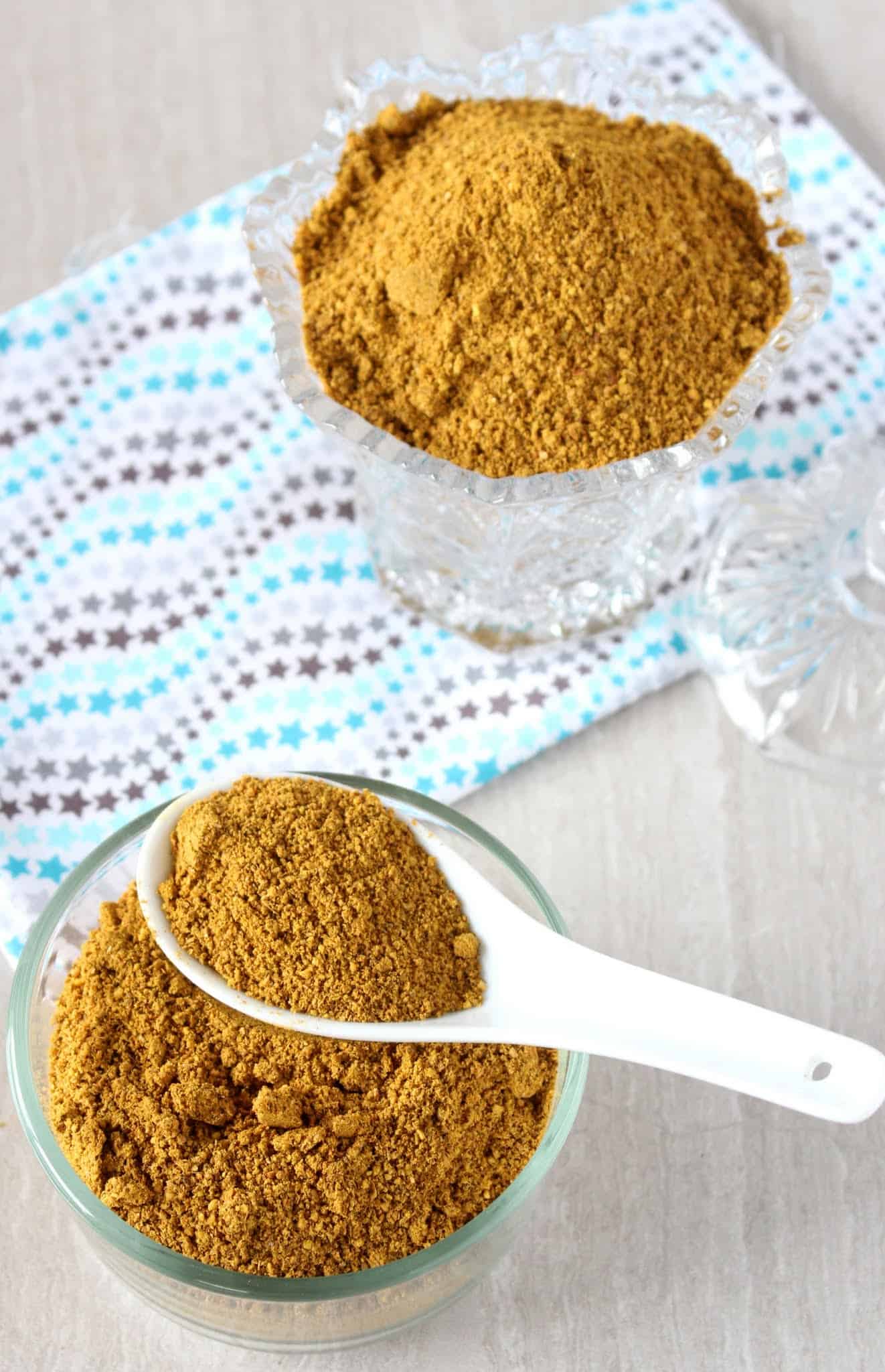 Flavorful Rasam Powder in a jar and bowl and scooped in spoon