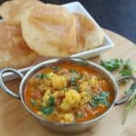 Cauliflower Kurma in bowl with poori