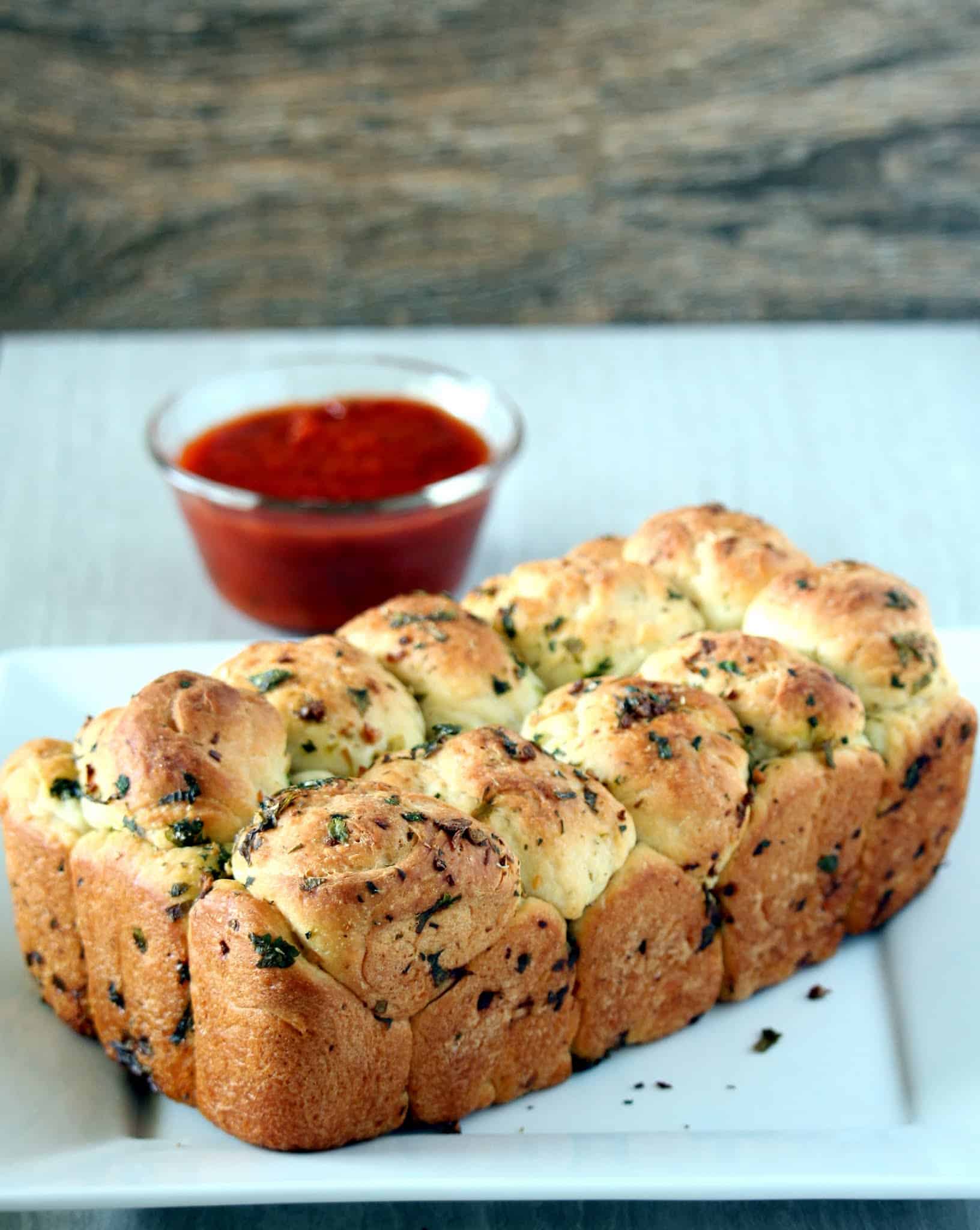 Pull apart Garlic Bread with tomato sauce in the background