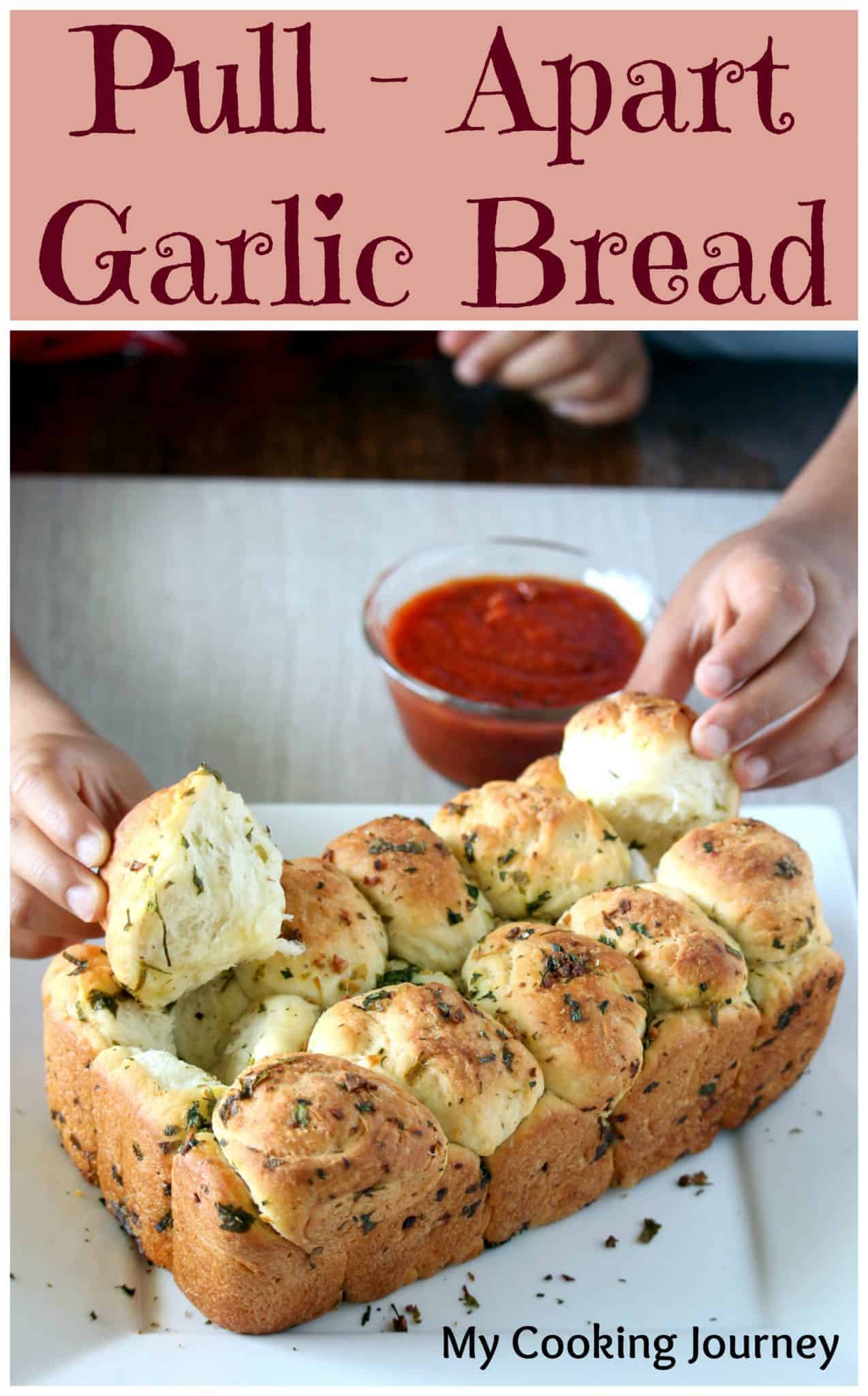 pulling our garlic bread pieces from a loaf