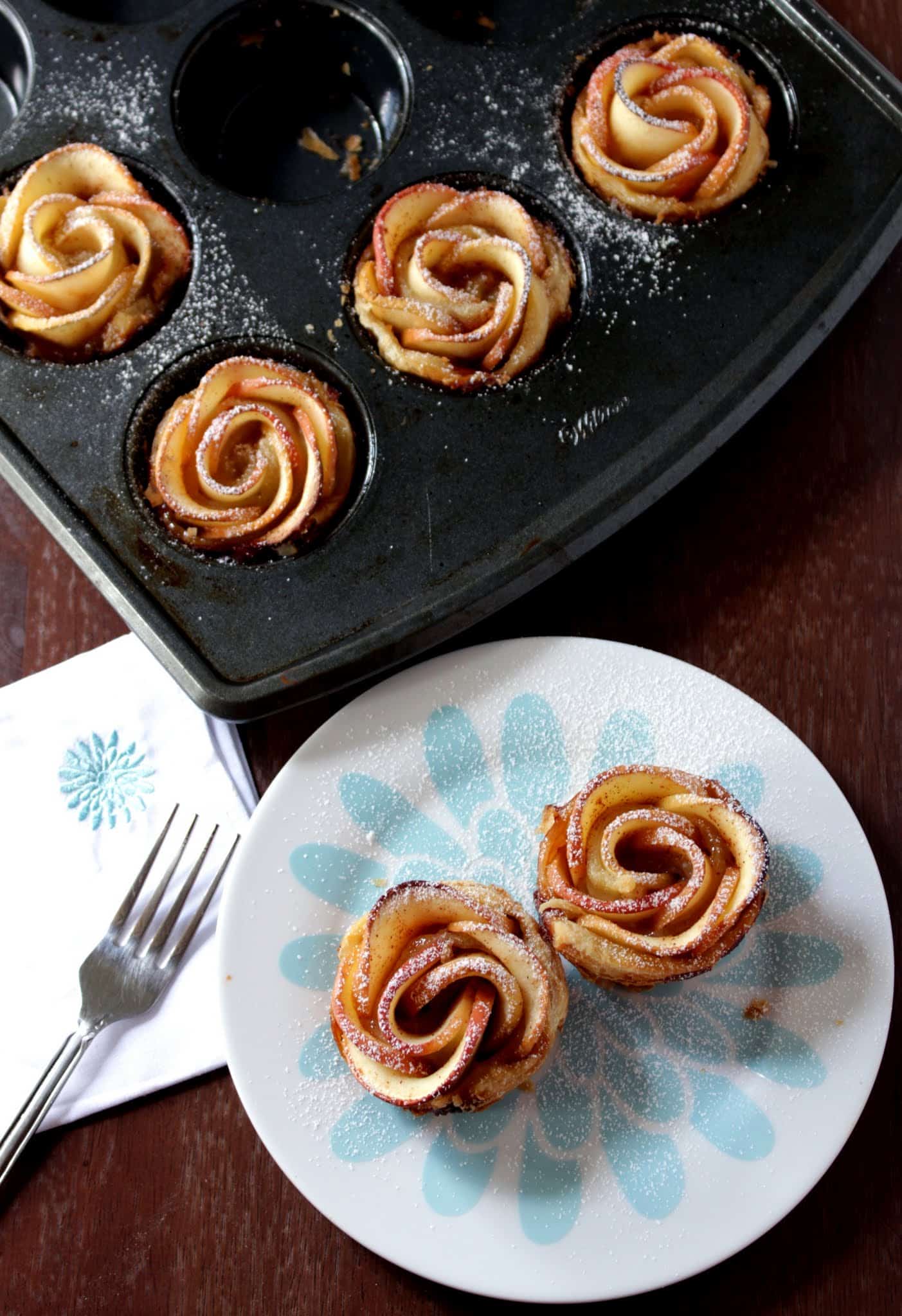Baked Apple Roses With Puff Pastry in the tray and served in plate with fork on side