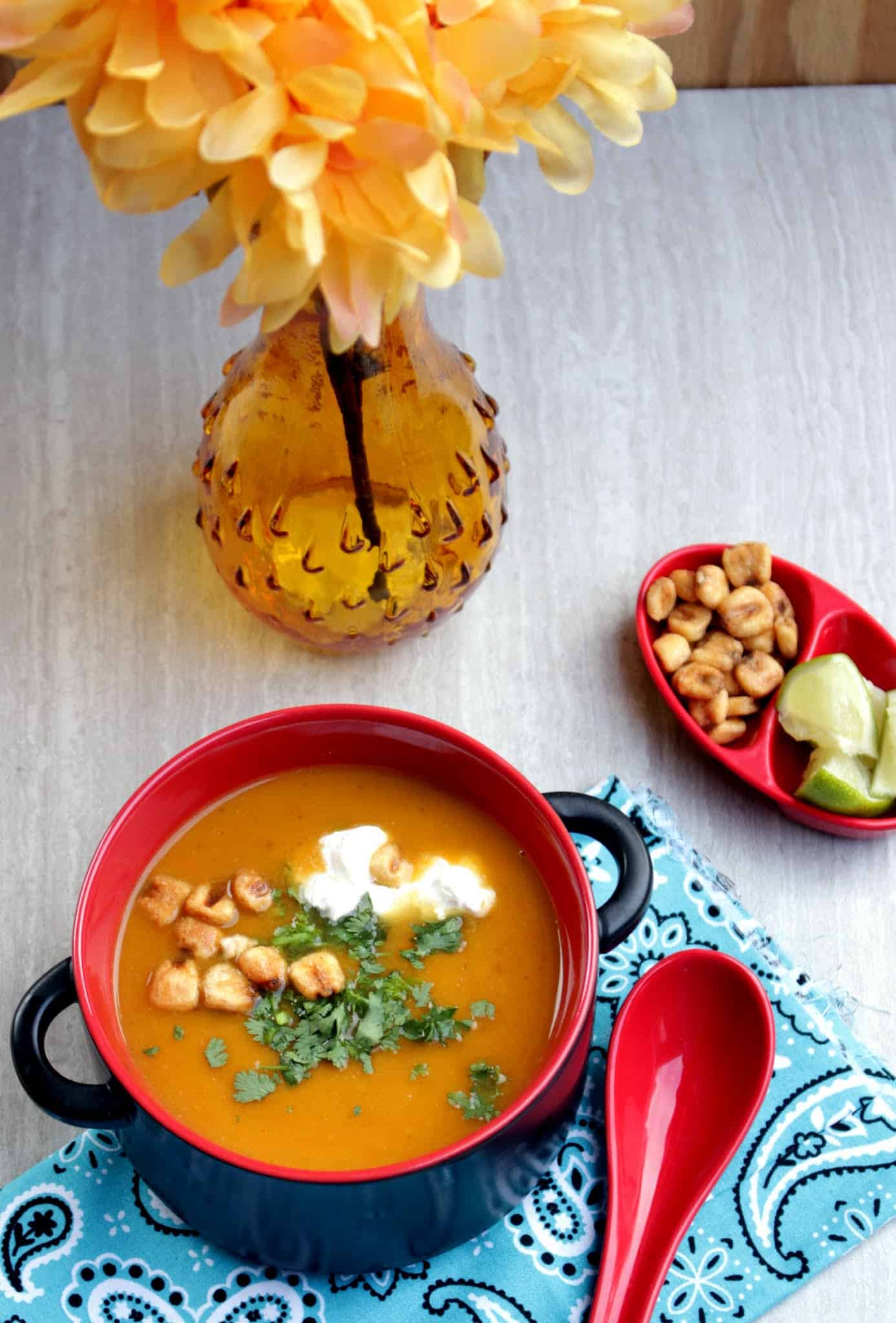 Roasted Butternut Squash Soup with lemon and flower  in background