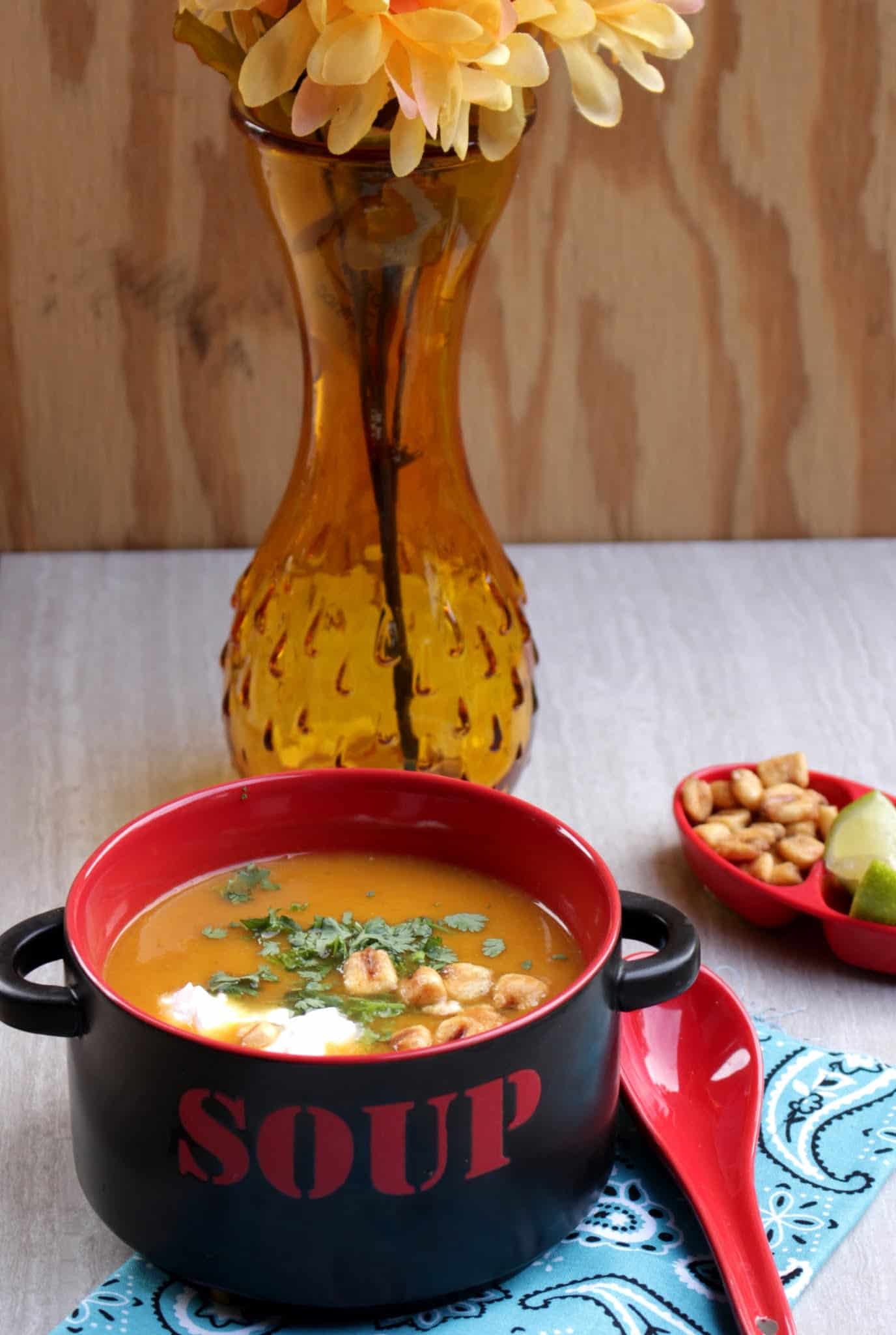 Mexican Flavored Butternut Squash Soup served in a bowl with red spoon