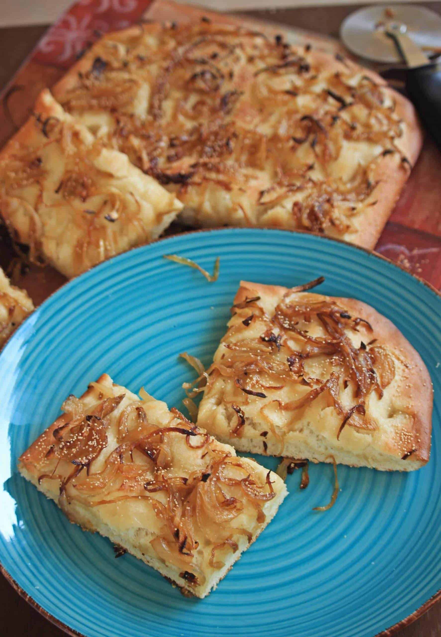 Onion and Poppy Seed Pletzel | Onion Bread Board Onion and Poppy Seed Pletzel in a blue pate