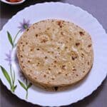 whole wheat flatbread stacked and ghee rubbed on top.