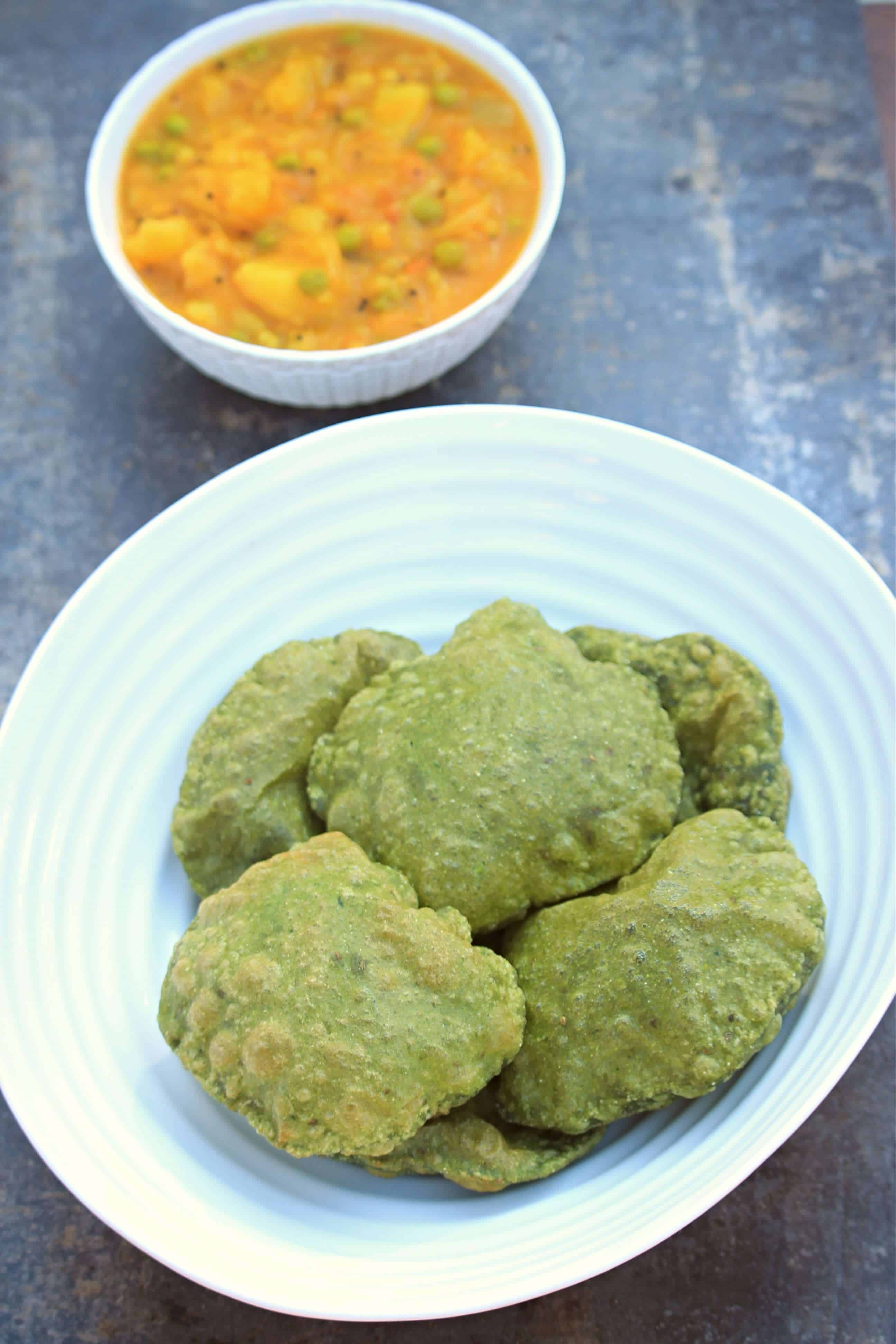 palak puri with potato curry in the background