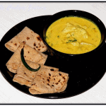 Pahari Aloo Palda – Potatoes Simmered in Yogurt Gravy in a Plate