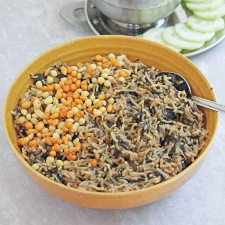 spinach rice in a bowl with spoon