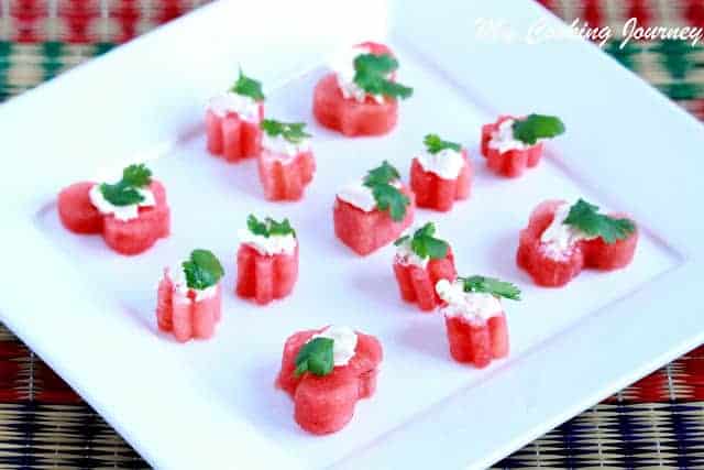 watermelon appetizer garnished with cheese and mint