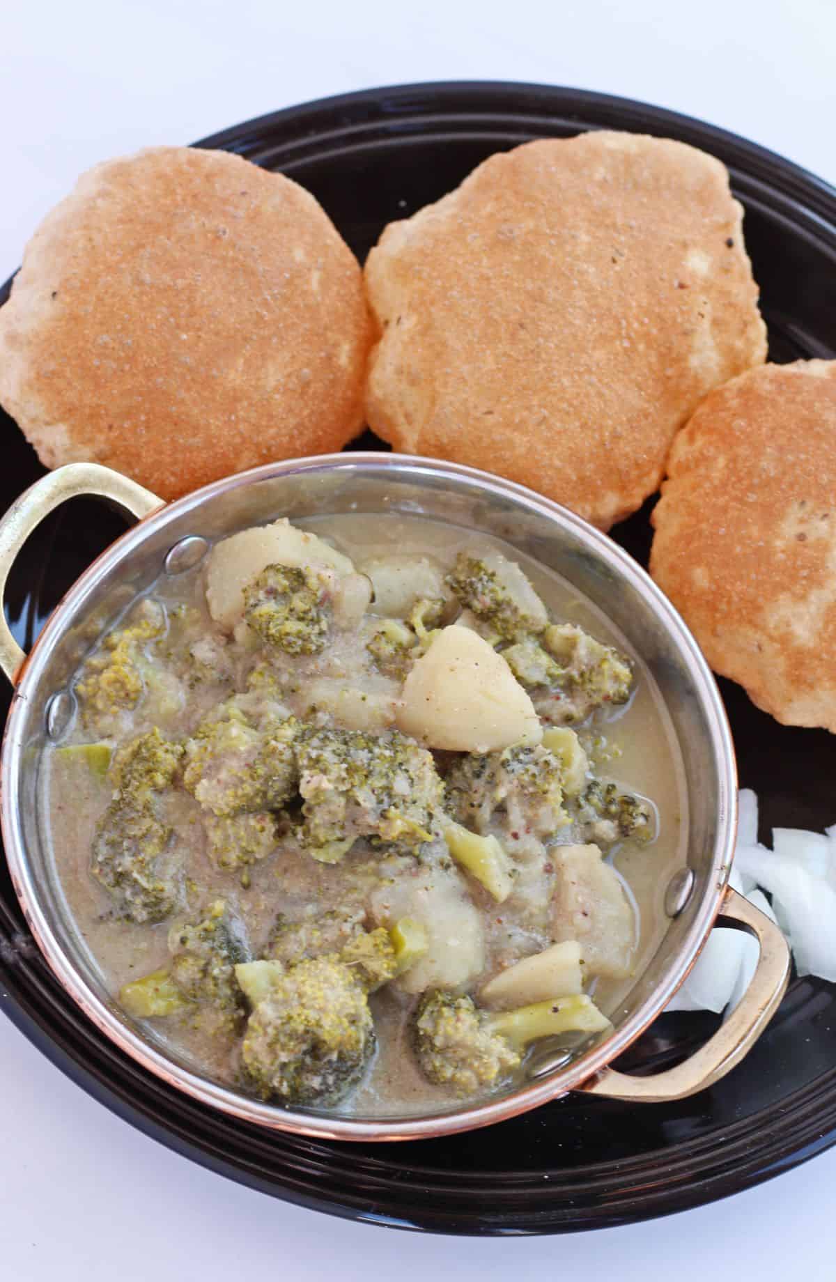 broccoli and potato in a curry with poori