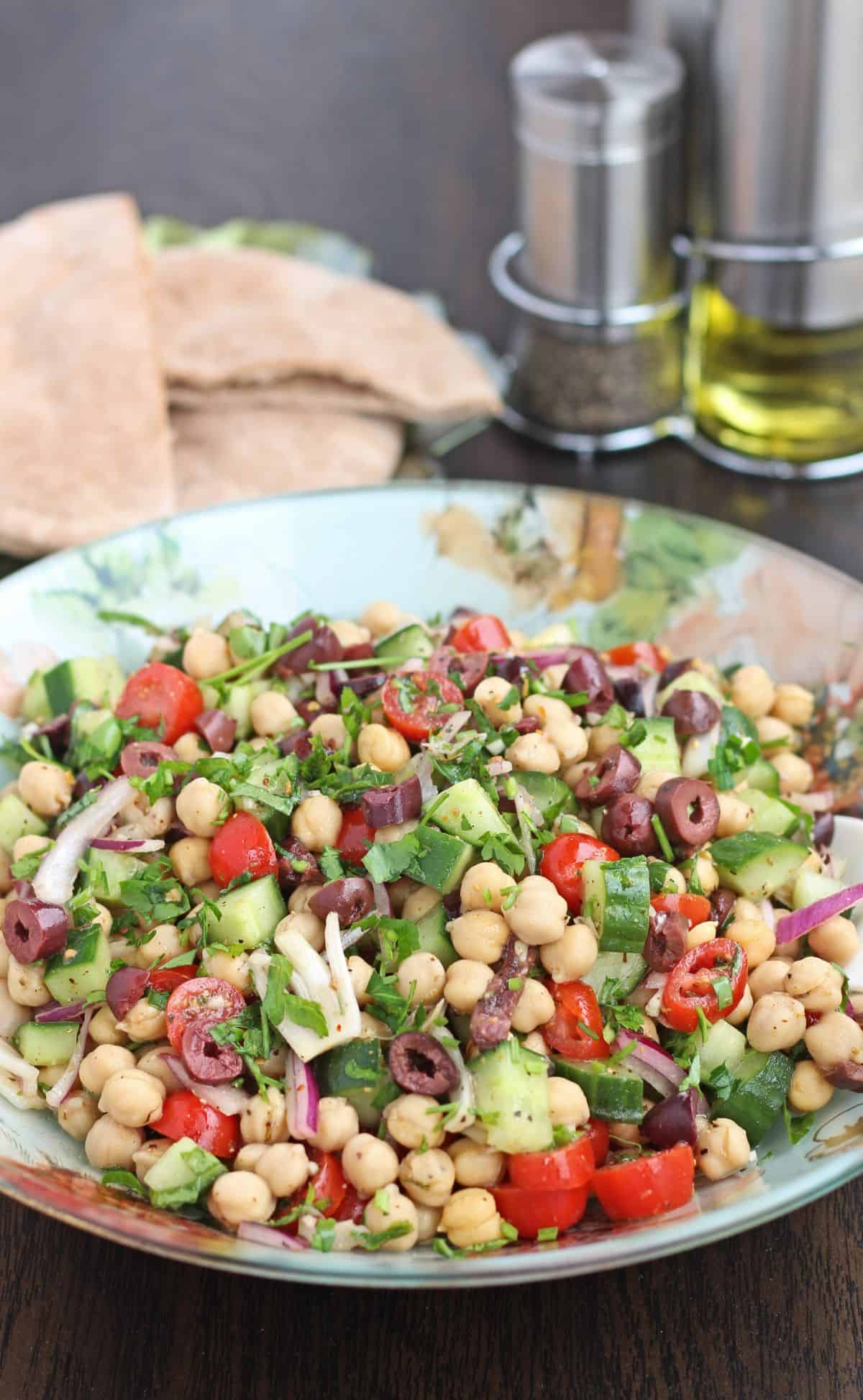 salad with chickpeas, tomato, olive, cucumber and greens
