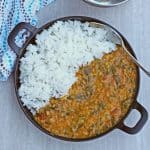 dal tadka with rice on a black serveware