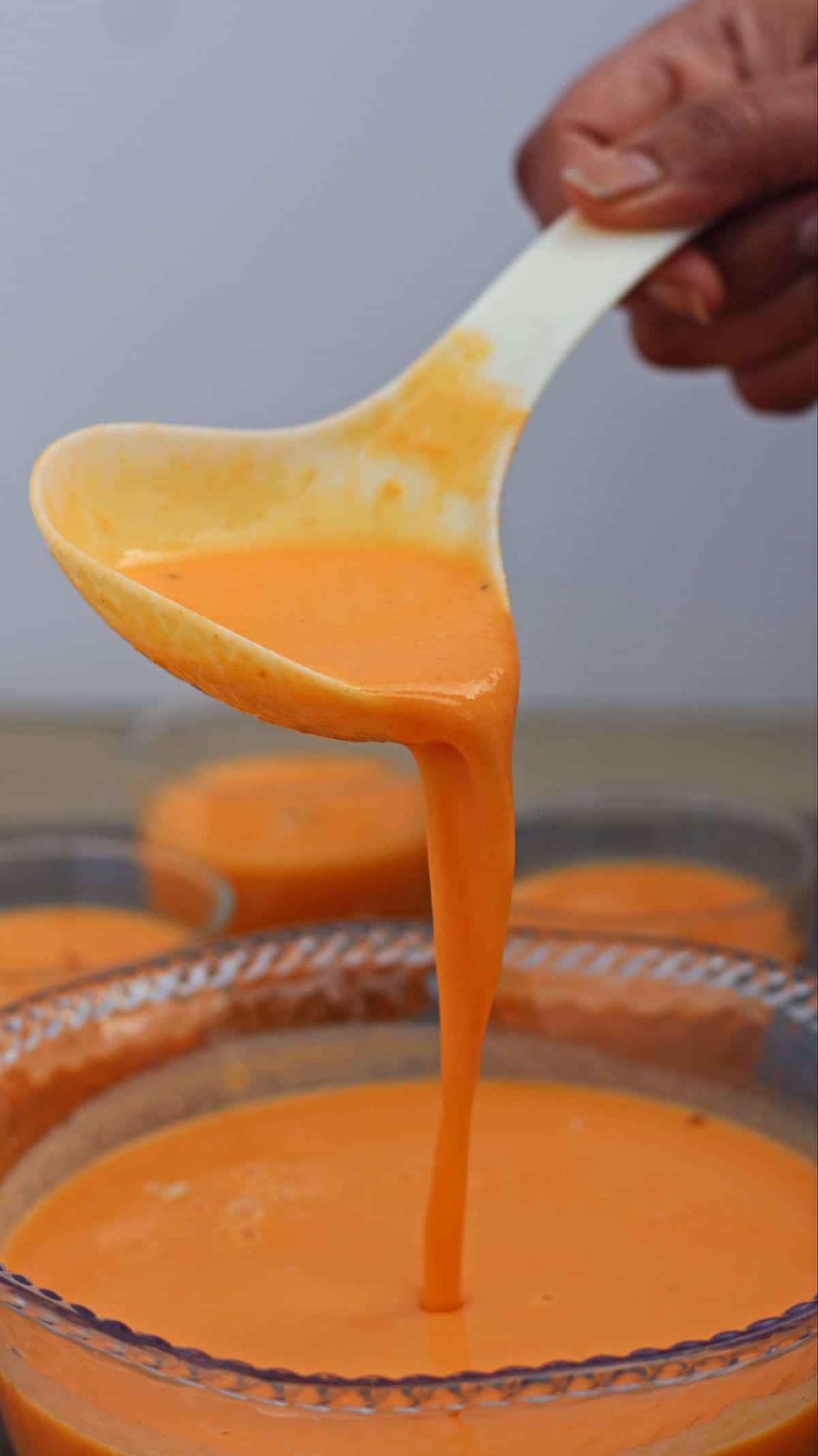 carrot kheer pouring from a ladle