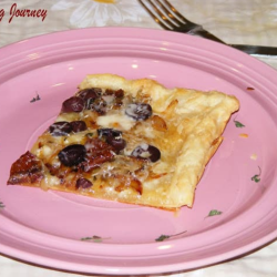 Sun Dried Tomato And Onion Tart served in a Plate
