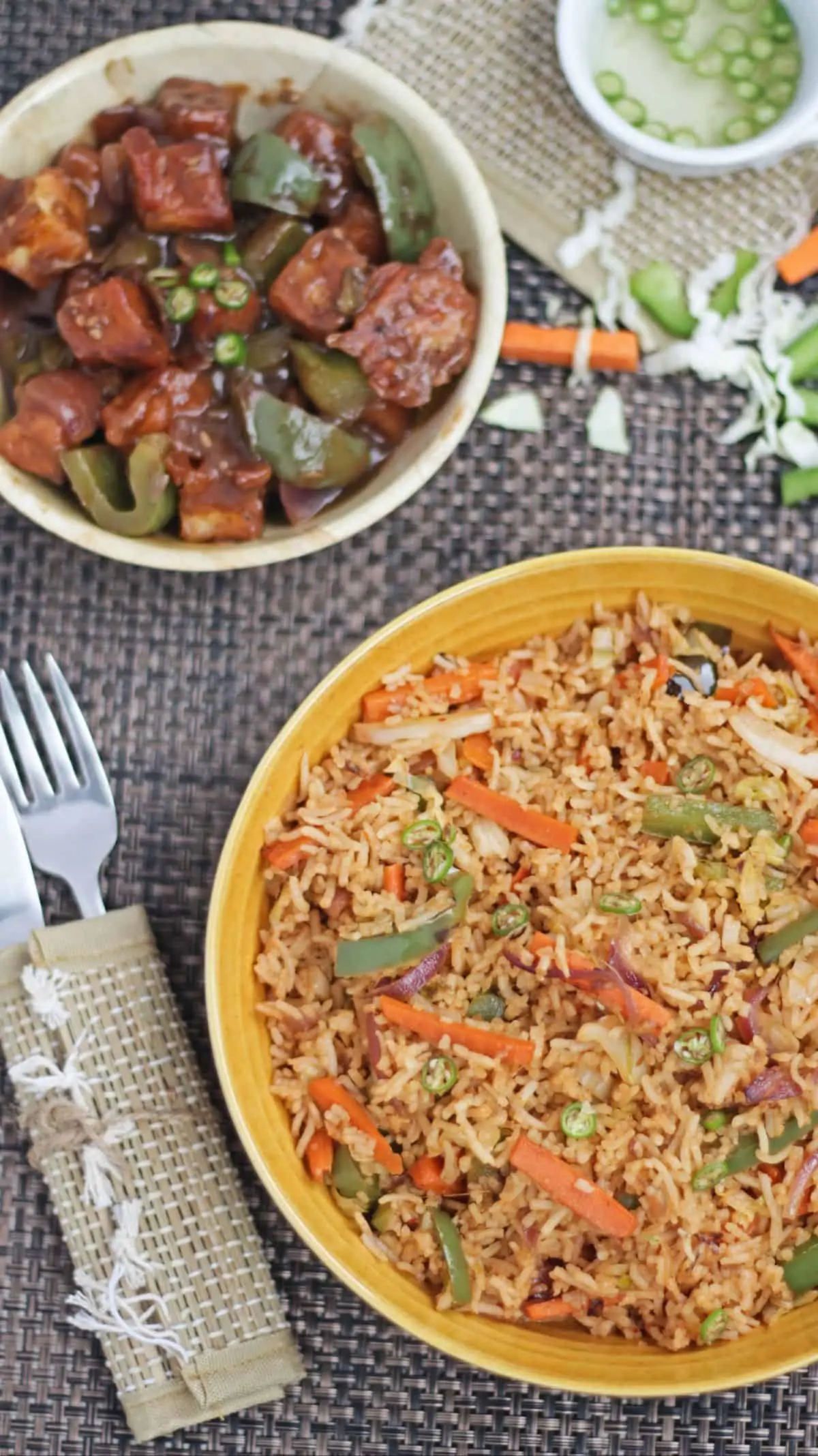 Schezwan fried rice in a bowl with side dish