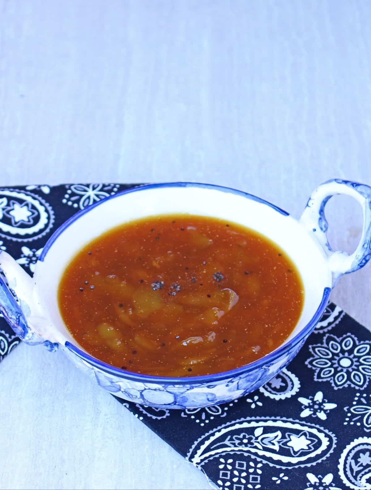 raw mangai pachadi in a bowl with mustard seeds