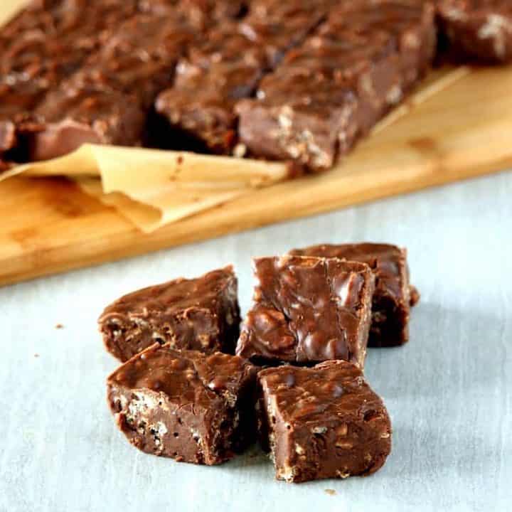 3 ingredient chocolate fudge on a cutting board and few in the front of it - Featured Image.