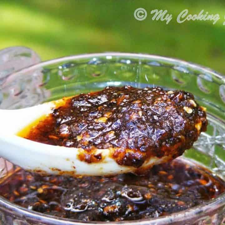 Vegetarian Chilli Paste in a container and spoon - Close up view