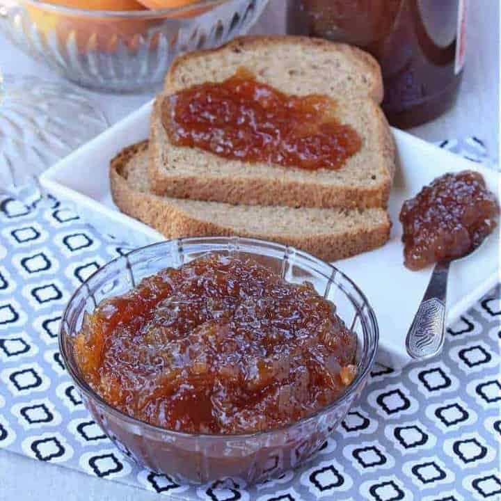 Spice apple jam in a glass bowl with bread on the side - Featured Image.