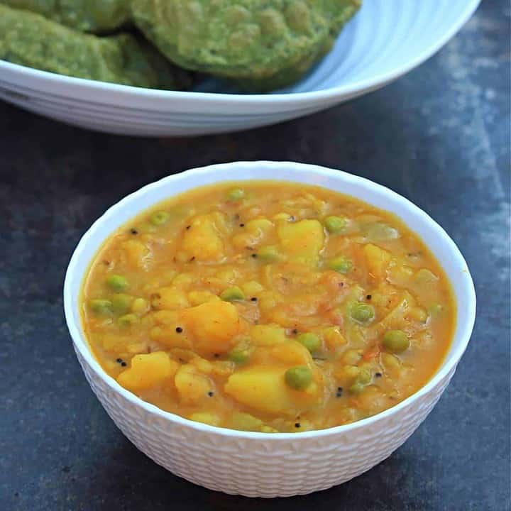 Potato Masala in a bowl with poori on the side - Featured Image