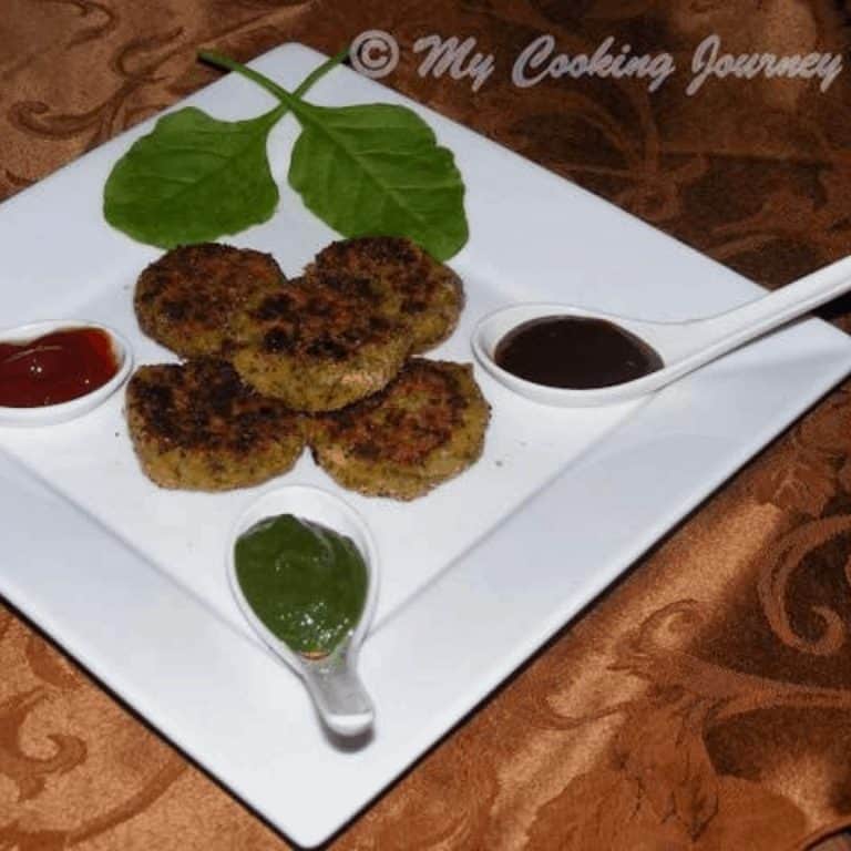 Green Cutlets in a white plate with chutneys on side - Feature Image