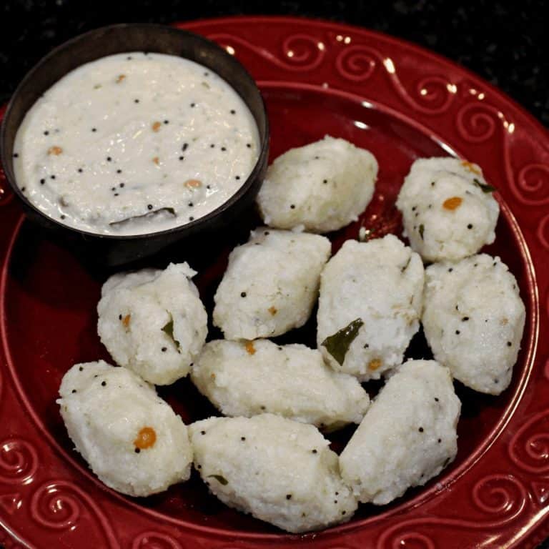 Puzhungal Arisi Pidi Kozhukattai in a red plate with Chutney on the side - Feature Image